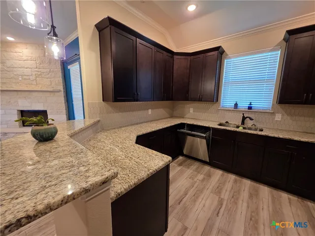 a kitchen with a sink and cabinets
