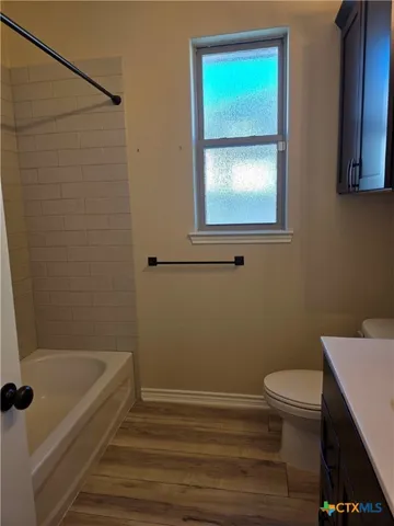 a bathroom with a toilet and a sink