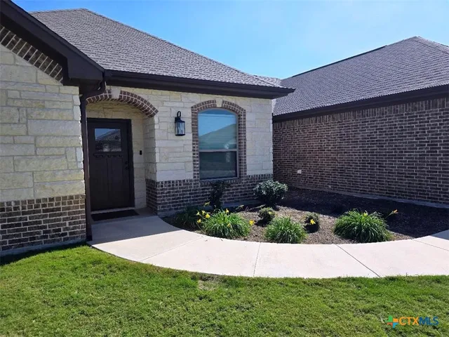 a front view of a house with a garden