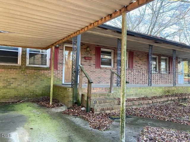 a view of a brick house with large windows