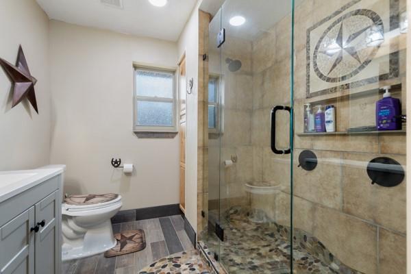 7766 North State Highway 78 Ravenna, TX 75476 - Photo 19 of 39 Bathroom featuring vanity, a shower stall, wood tiled floors, and recessed lighting