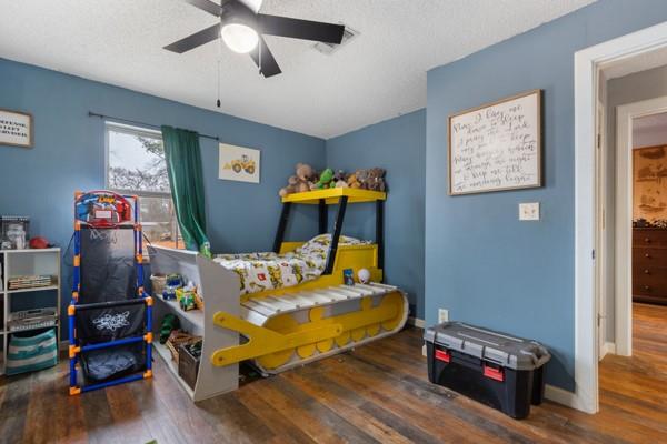 7766 North State Highway 78 Ravenna, TX 75476 - Photo 20 of 39 Bedroom with dark wood finished floors, a textured ceiling, and a ceiling fan