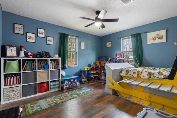 7766 North State Highway 78 Ravenna, TX 75476 - Photo 21 of 39 Bedroom featuring hardwood / wood-style floors, a ceiling fan, and a textured ceiling