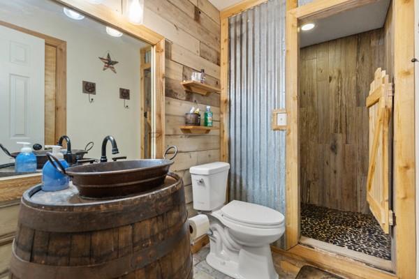 7766 North State Highway 78 Ravenna, TX 75476 - Photo 23 of 39 Full bath with wooden walls, vanity, and tiled shower