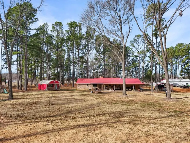 a view of a house with backyard porch and sitting area