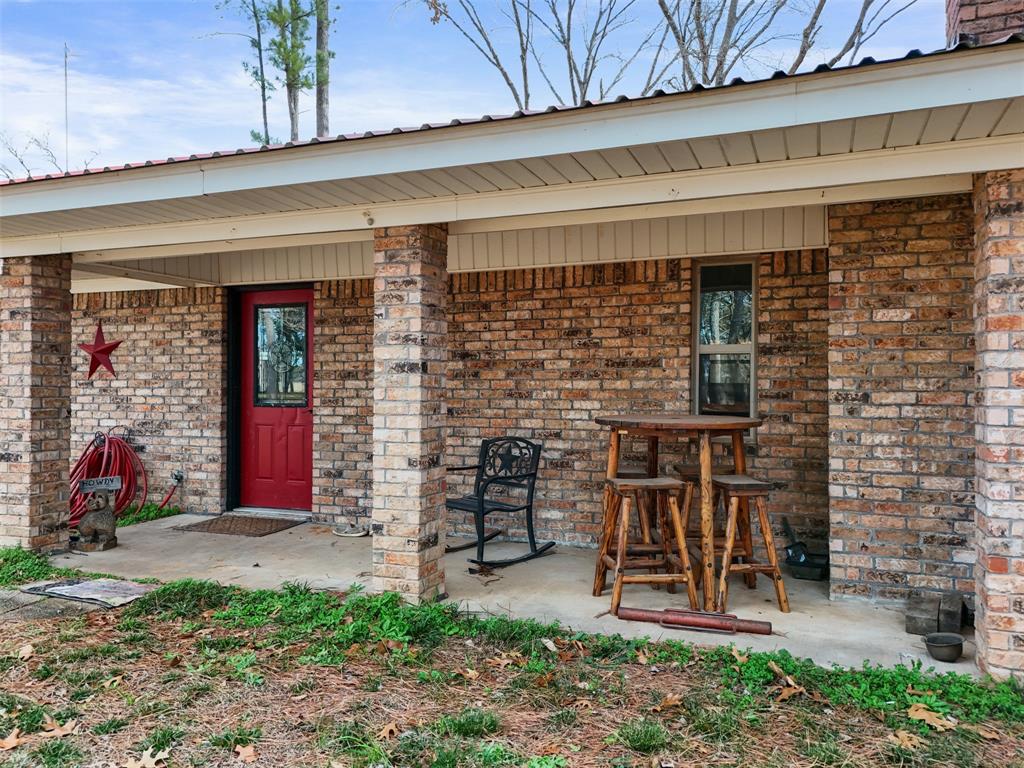 7766 North State Highway 78 Ravenna, TX 75476 - Photo 3 of 39 View of exterior entry featuring brick siding