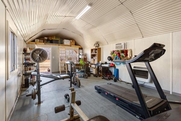 7766 North State Highway 78 Ravenna, TX 75476 - Photo 35 of 39 Exercise area featuring lofted ceiling, AC wall unit and gas heater