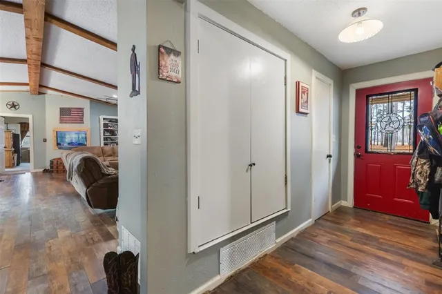 a view of a hallway with furniture and windows