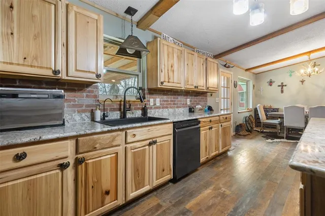 a kitchen with lots of counter top space and wooden floor