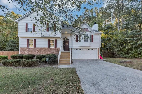 a house that has a tree in front of the house