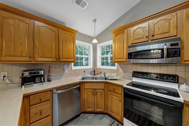 a bedroom with a bed couch and a window