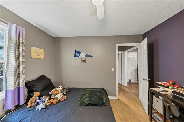 a kitchen with a refrigerator a stove a sink dishwasher and wooden cabinets with wooden floor