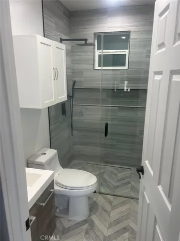a bathroom with a toilet and a shower