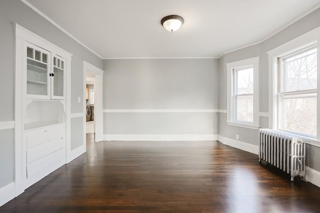 27-29 Brookvale Street Boston, MA 02124 - Photo 28 of 42 an empty room with wooden floor and windows