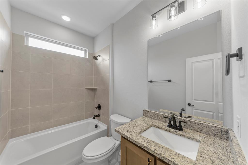 3405 Heathrow Road Mesquite, TX 75181 - Photo 27 of 30 a bathroom with a granite countertop sink toilet and shower