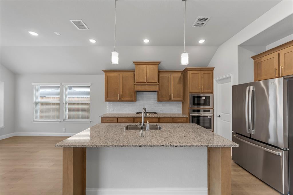 3405 Heathrow Road Mesquite, TX 75181 - Photo 5 of 30 a kitchen with stainless steel appliances granite countertop a sink and a refrigerator