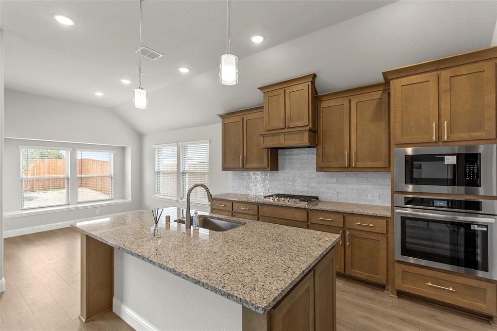 3405 Heathrow Road Mesquite, TX 75181 - Photo 6 of 30 a kitchen with granite countertop kitchen island a sink appliances and cabinets