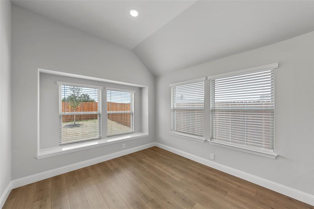 3405 Heathrow Road Mesquite, TX 75181 - Photo 8 of 30 a view of an empty room with wooden floor and window