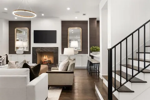 a living room with fireplace furniture and a flat screen tv