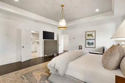 a spacious bedroom with a bed and a large window