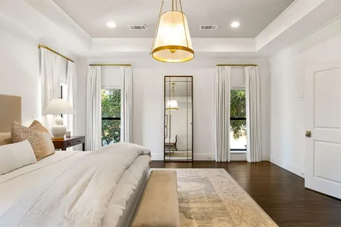 a bathroom with a double vanity sink a mirror a bathtub and