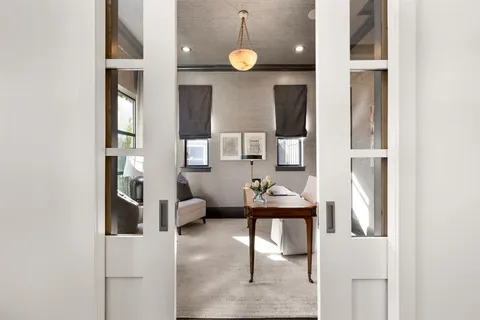 a view of a dining room with furniture and a window