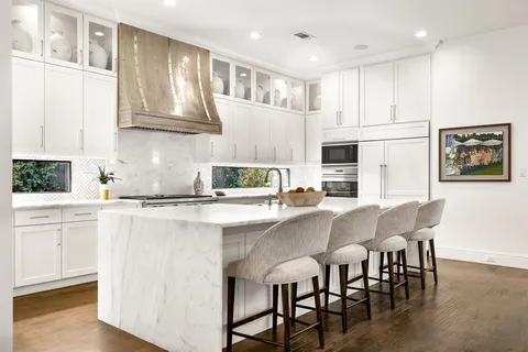 a white stove top oven sitting inside of a kitchen