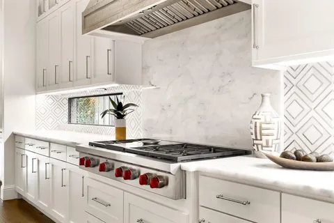 a large kitchen with stainless steel appliances granite countertop a lot of counter space and wooden floors