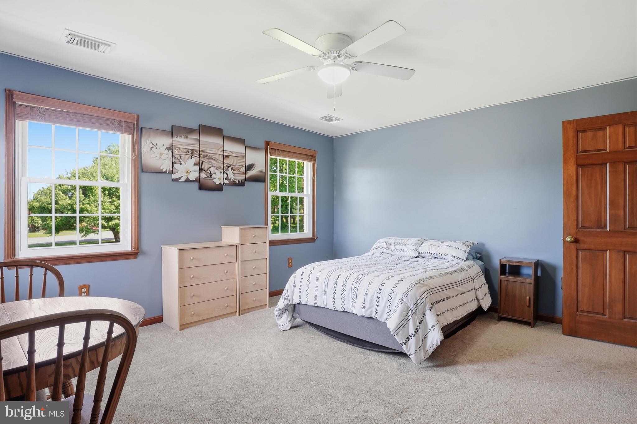 6118 Fishers Station Road Lothian, MD 20711 - Photo 29 of 62 a bedroom with a bed next to a window with a dresser