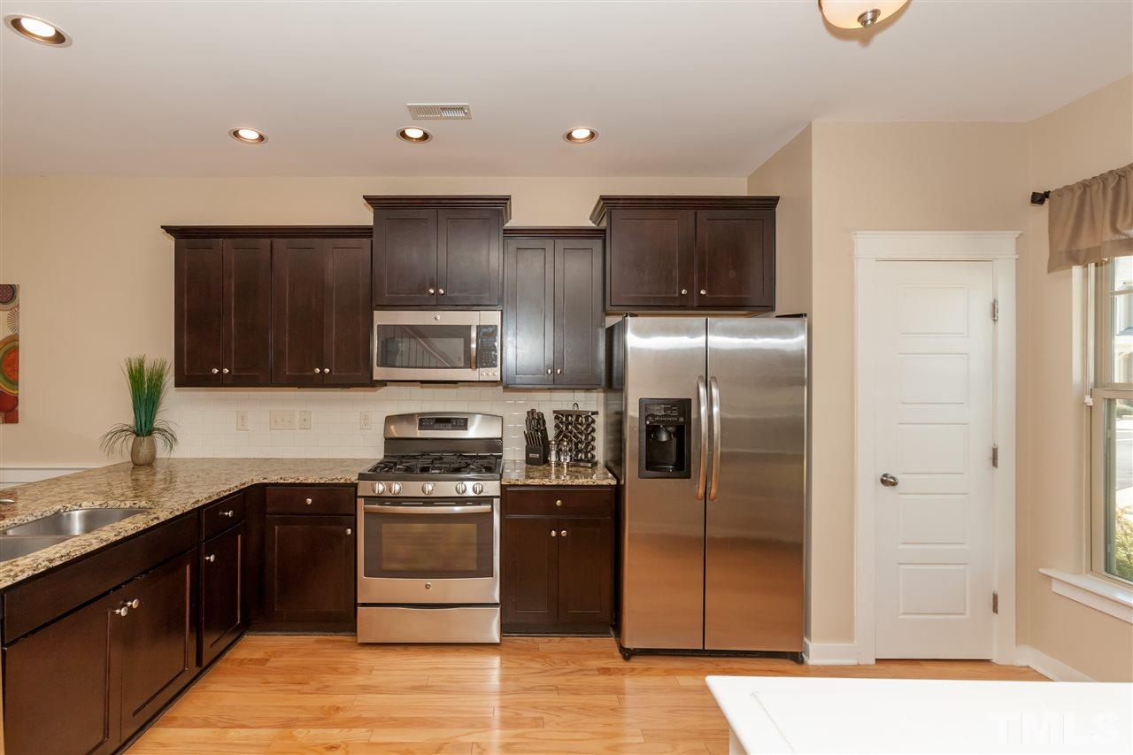 7811 Lillyhurst Drive Raleigh, NC 27612 - Photo 12 of 25 a kitchen with a refrigerator and a sink