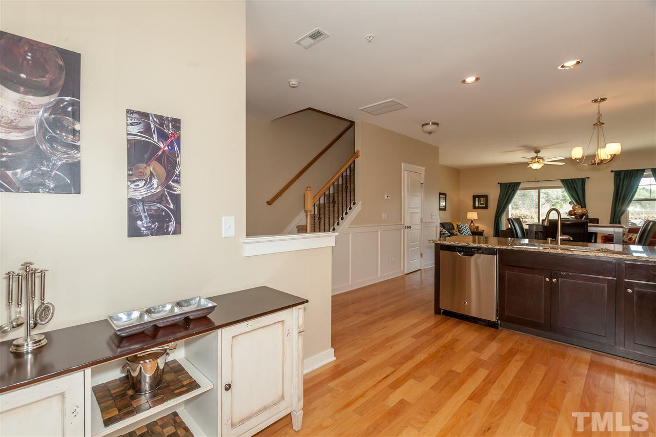 7811 Lillyhurst Drive Raleigh, NC 27612 - Photo 13 of 25 a kitchen with granite countertop a stove and a sink