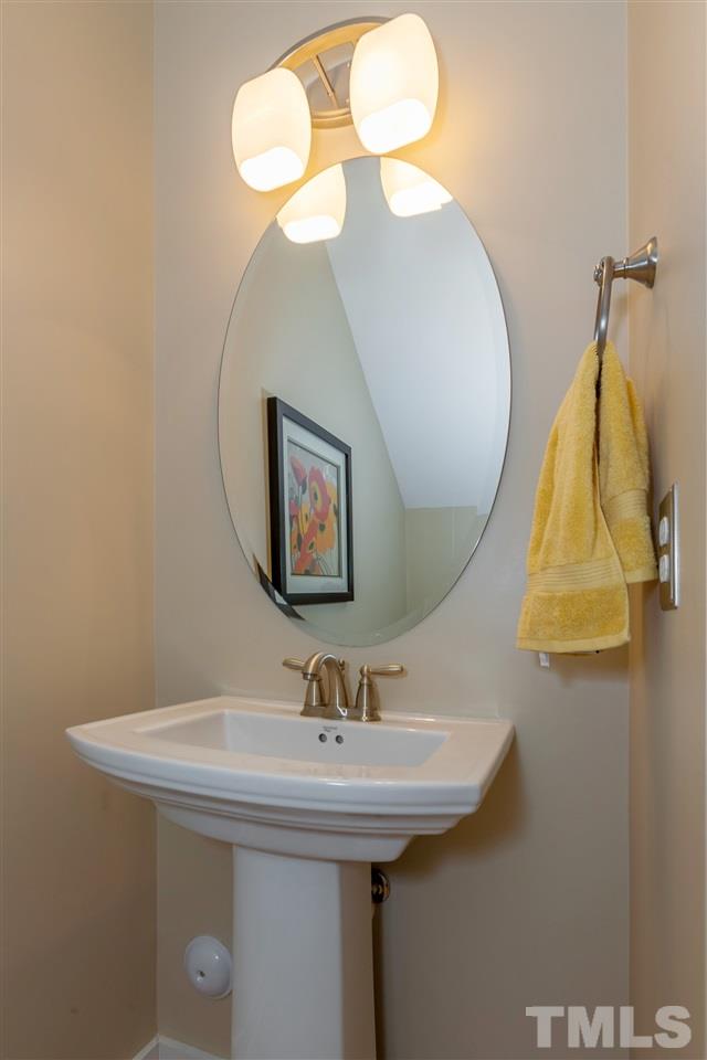 7811 Lillyhurst Drive Raleigh, NC 27612 - Photo 14 of 25 a bathroom with a sink and mirror