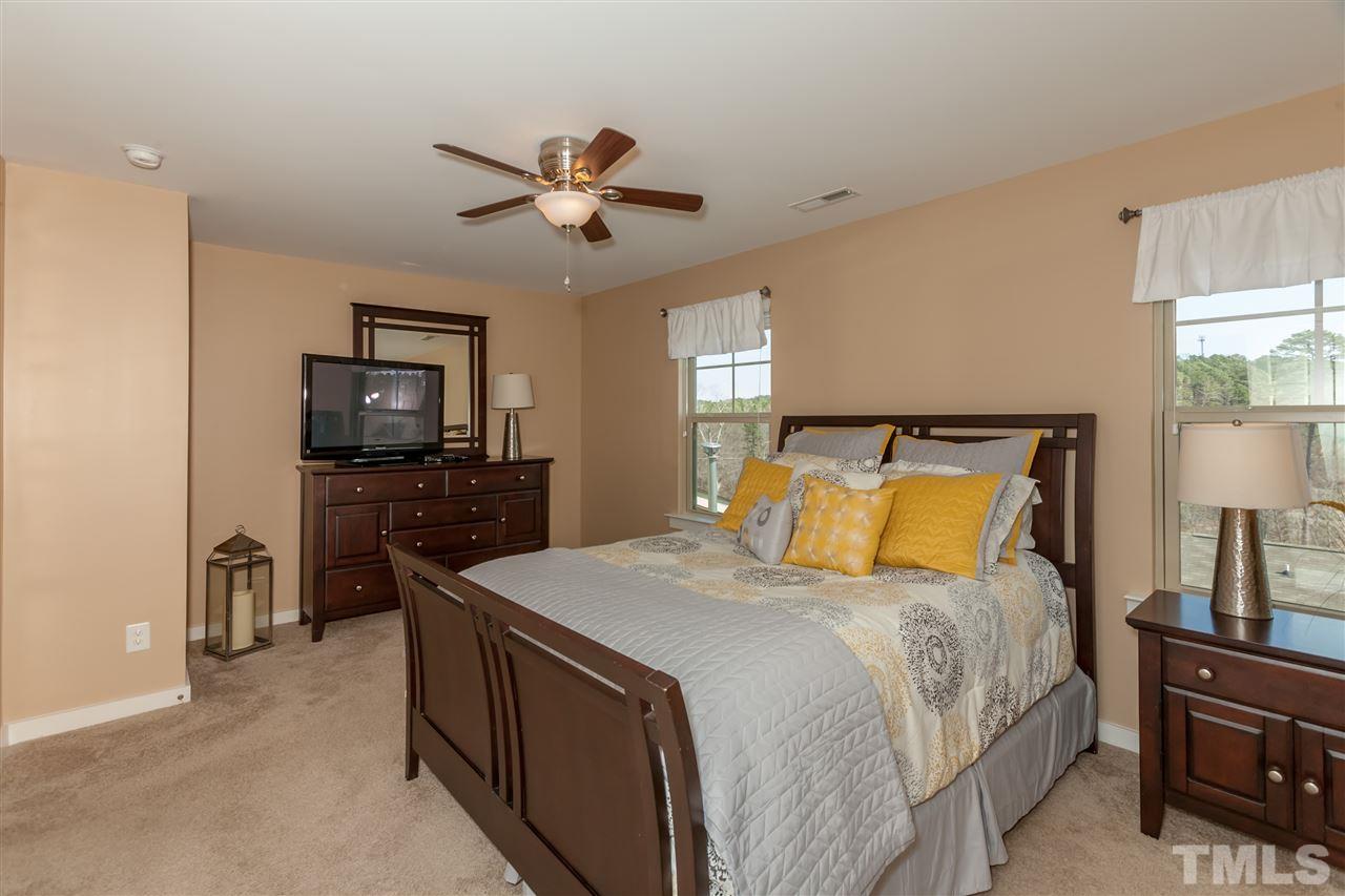 7811 Lillyhurst Drive Raleigh, NC 27612 - Photo 15 of 25 a bedroom with a bed and a flat screen tv