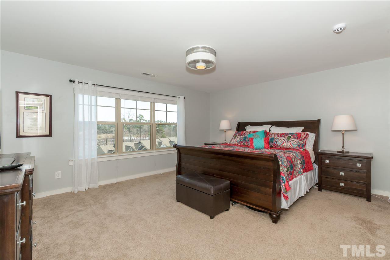 7811 Lillyhurst Drive Raleigh, NC 27612 - Photo 20 of 25 a spacious bedroom with a bed and a window