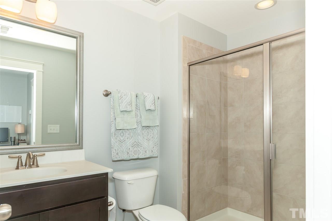 7811 Lillyhurst Drive Raleigh, NC 27612 - Photo 23 of 25 a bathroom with a sink a toilet and shower