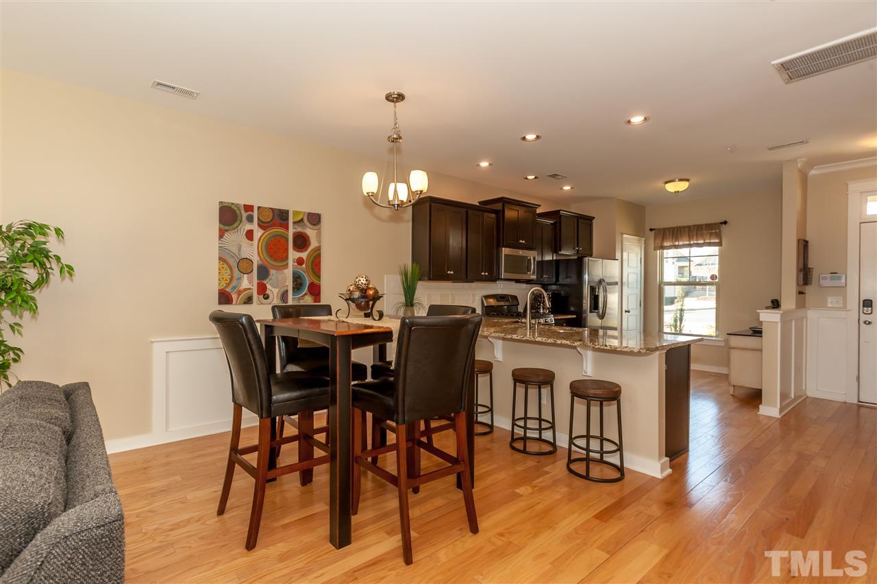 7811 Lillyhurst Drive Raleigh, NC 27612 - Photo 6 of 25 a view of a dining room with furniture and wooden floor