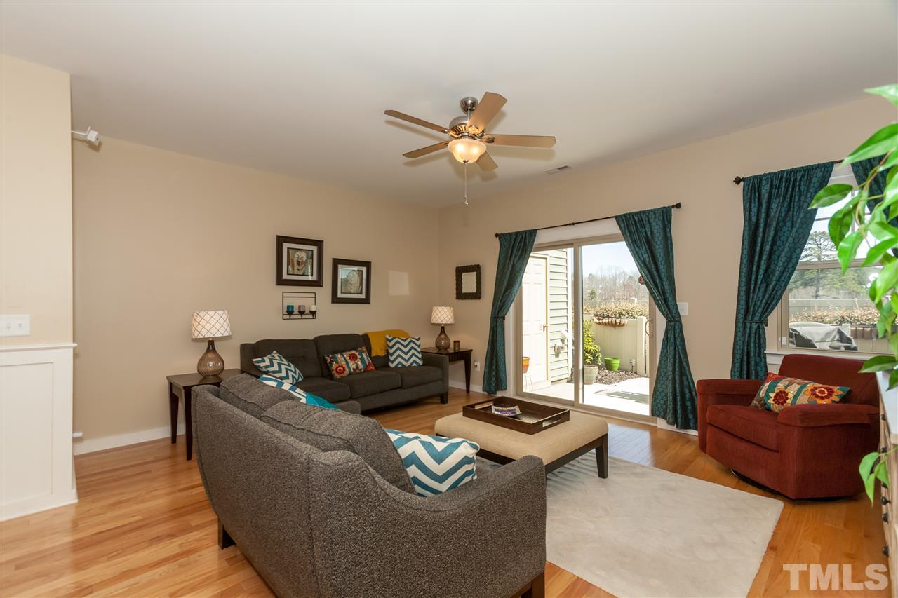 7811 Lillyhurst Drive Raleigh, NC 27612 - Photo 8 of 25 a living room with furniture and a large window