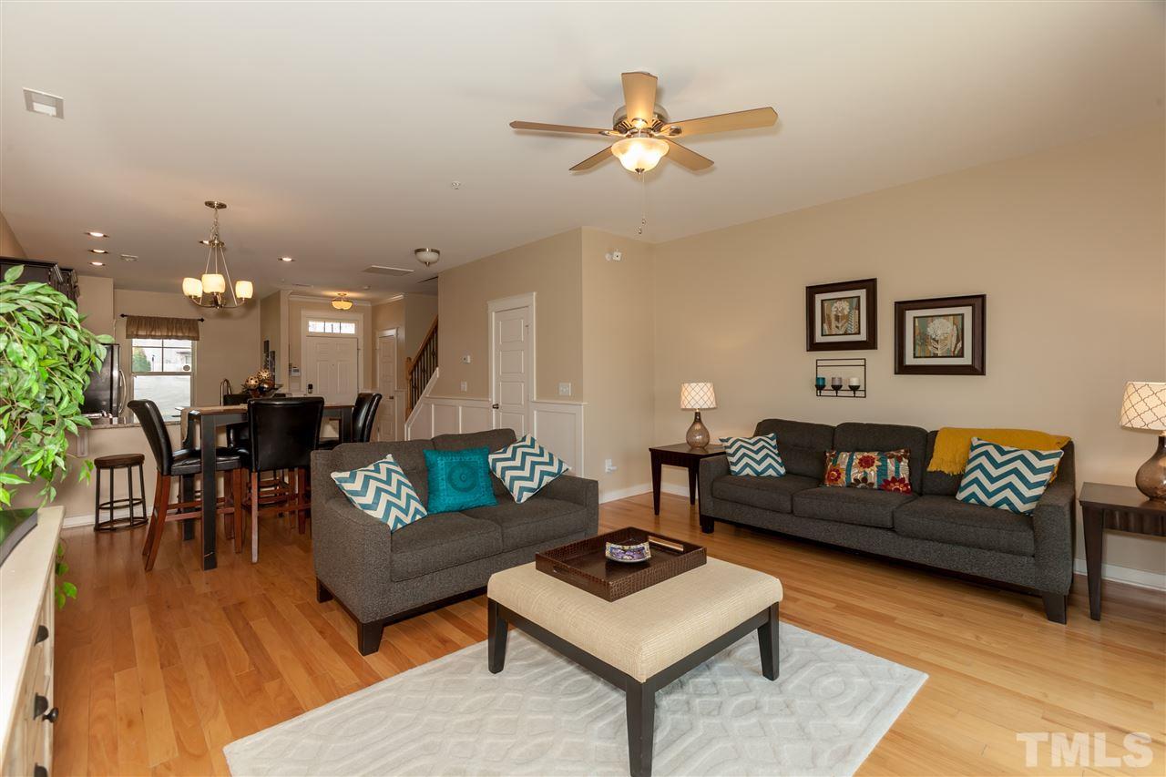 7811 Lillyhurst Drive Raleigh, NC 27612 - Photo 9 of 25 a living room with furniture and a dining table with wooden floor