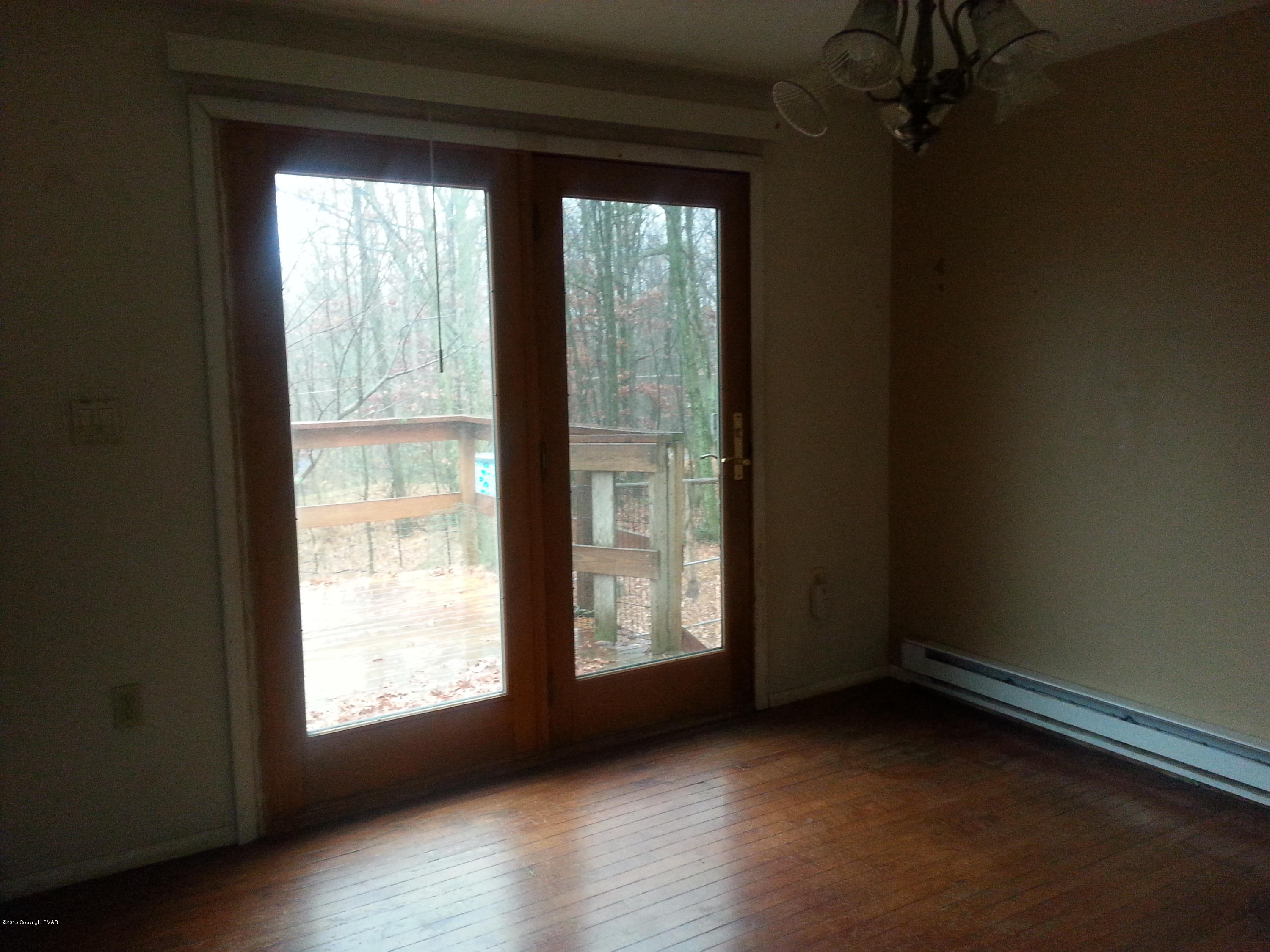 1612 Silver Maple Road Effort, PA 18330 - Photo 8 of 27 a view of an empty room with wooden floor and a window