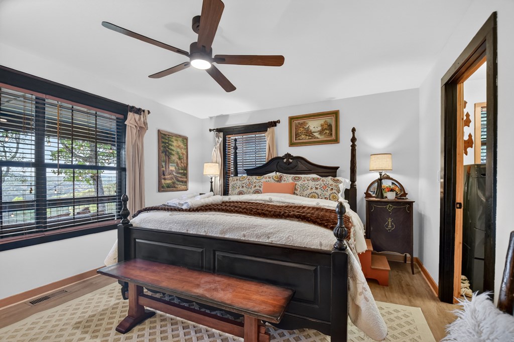 329 Robinson Thomas Road Morganton, GA 30560 - Photo 27 of 96 a bedroom with a bed and a chandelier