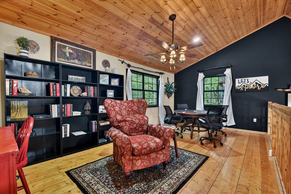 329 Robinson Thomas Road Morganton, GA 30560 - Photo 43 of 96 a living room with furniture hard wood floor and a book shelf