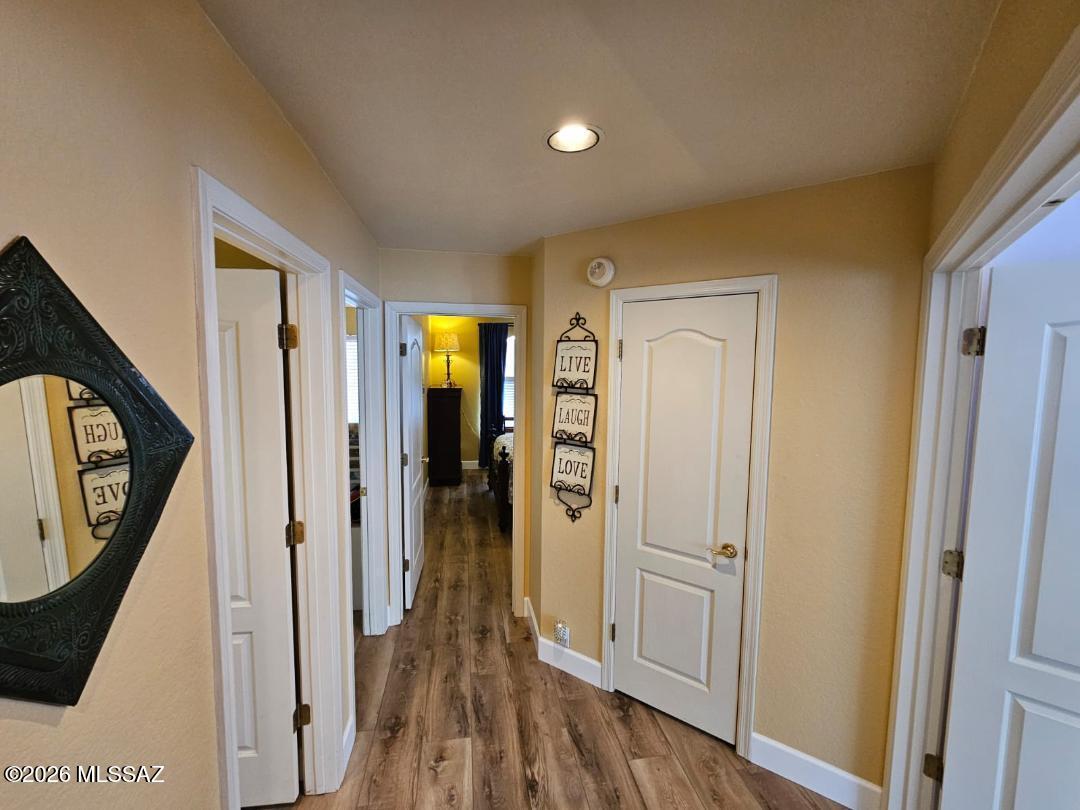 3130 West Star Ranch Trail Tucson, AZ 85742 - Photo 27 of 44 a view of a hallway with wooden floor and staircase