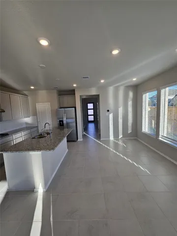 a view of a kitchen with a sink and cabinets