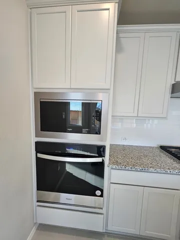 a view of a kitchen with a sink and cabinets