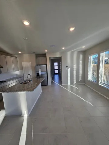 a view of a livingroom with wooden floor and staircase