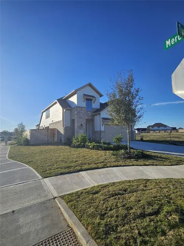 a view of a large house with a yard and large trees