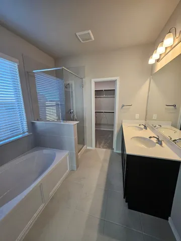 a bathroom with a sink double vanity and a mirror
