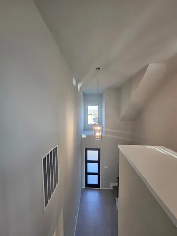 an empty room with a empty space and windows