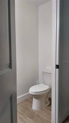 a white toilet sitting next to a shower