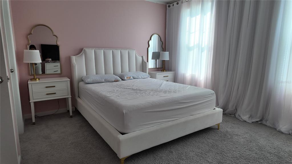 8599 Sportsman Loop Groveland, FL 34736 - Photo 17 of 19 a bedroom with a bed and a window